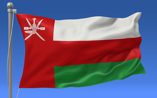 Oman flag waving on the flagpole on a sky background