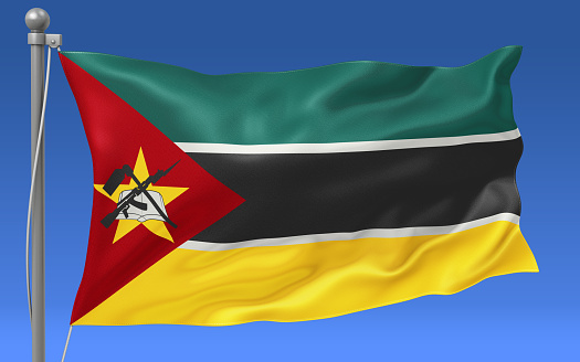 Mozambique flag waving on the flagpole on a sky background