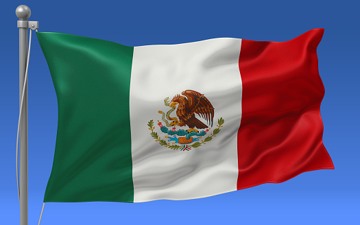 Mexico flag waving on the flagpole on a sky background