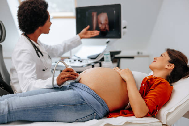 Pregnant woman on ultrasound. stock photo