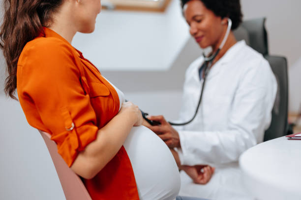 istock African American ob-gyn with pregnant patient. 1440799956