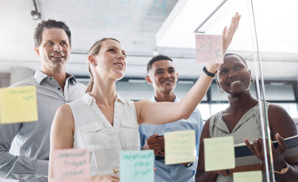 istock Idea wall, post it and team conversation with business strategy brainstorm notes in glass room. Vision board goal planning in professional corporate meeting discussion together at office. 1440800028