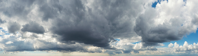 Panoramic view of rain clouds drawing nearer on a summer day.