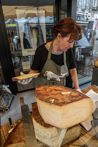 Auray, France - 05.09.2022 : A vendor selling cheese on Auray farmer agricultural market