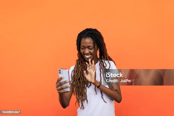 Young Black Woman Using Phone Stock Photo - Download Image Now - 20-24 Years, Adult, Adults Only