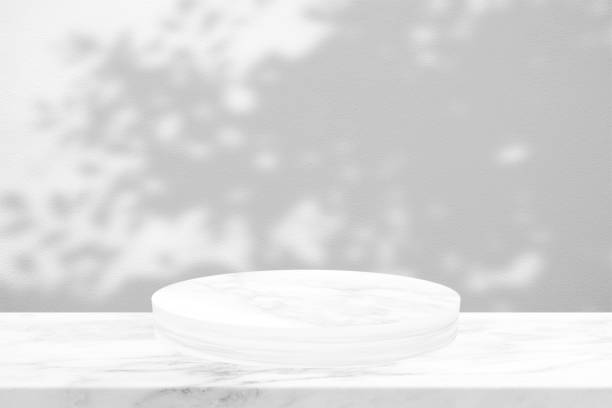 istock White Marble cylinder Podium with Shadow Leaves on Concrete Wall Texture Background, Suitable for Product Presentation Backdrop, Display, and Mock up. 1440804430