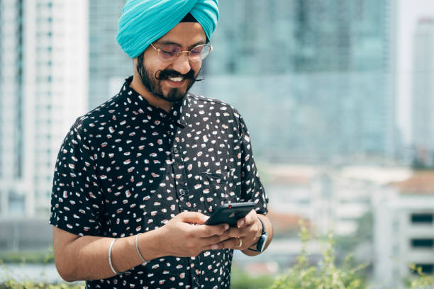 istock Happy Indian Businessman Using A Mobile Phone Outdoors 1440805208