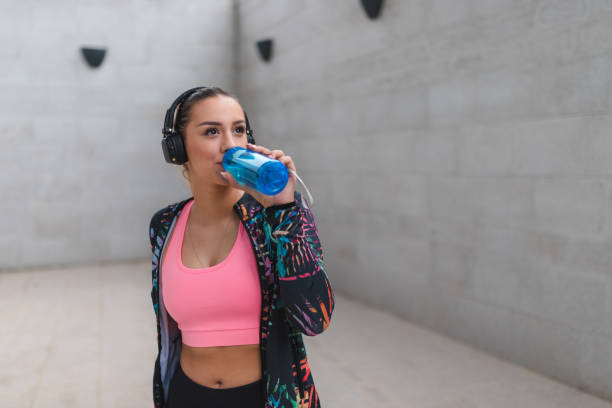 istock Fit young woman drinking water outdoors while taking a break from her workout 1440808215