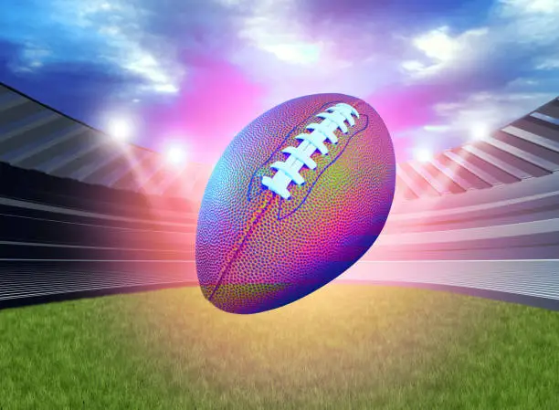 Glowing American football ball in a sports stadium or sport field as a team tournament in an arena for game playing competition as a 3D illustration.