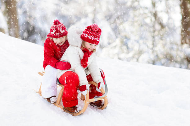 istock Kids on sleigh. Children sled. Winter snow fun. 1440809407