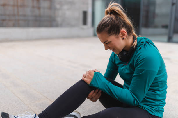 istock Young female athlete injured her knee outdoors while working out 1440809815