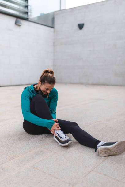 istock Young female athlete hurt her ankle while working out outdoors 1440809847