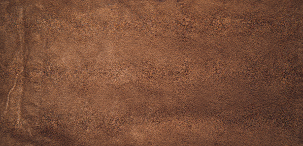 texture of dark brown colored raw leather background