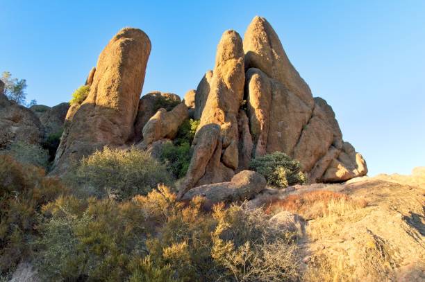 Pinnacles National Park ancient volcanic landscape in California. Colorful landscape with volcanic spires and wooded areas. Colorful spires along the Balconies trail.