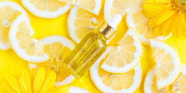 istock Essential oil, serum on textured background with yellow lemon slice 1440813295