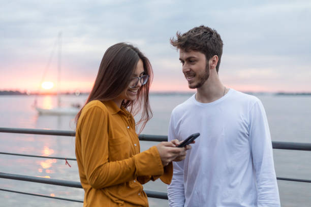 istock Loving couple on a pier taking selfie 1440814899
