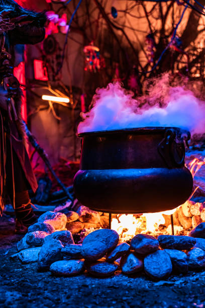istock Halloween concept.Horrible old witch brews witchcraft in her cauldron surrounded by magical blue light. 1440815225