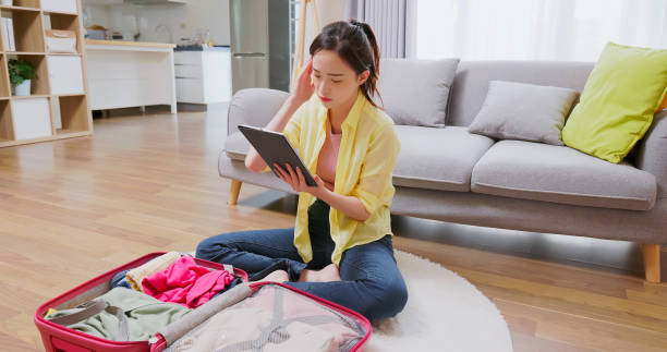 istock woman packing suitcase to travel 1440816770