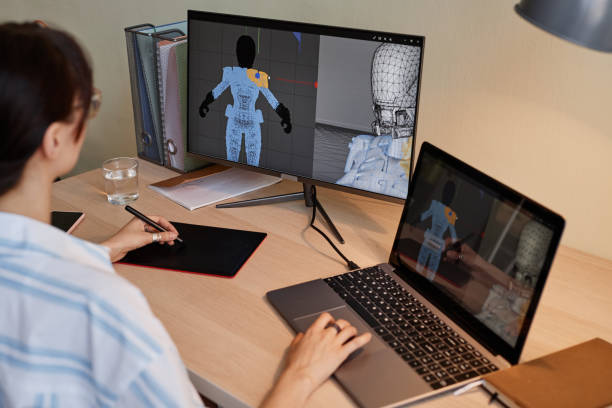 Female designer building digital 3D models for videogame