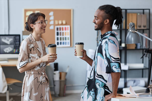 istock Young coworkers chatting in office 1440817374