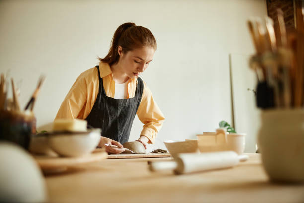 istock Female artist creating handmade ceramic bowl in cozy pottery studio 1440817551