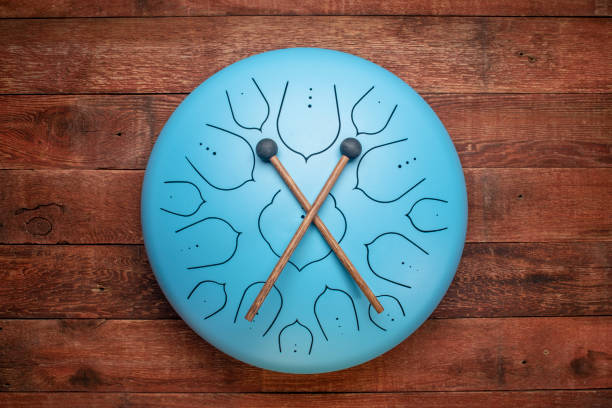 blue steel tongue drum with mallets blue steel tongue drum with mallets, top view against rustic barn wood steel drum stock pictures, royalty-free photos & images