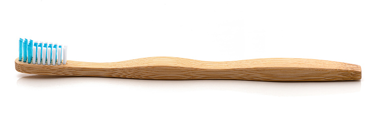 A toothbrush made of bamboo. \nIsolated on a white background.