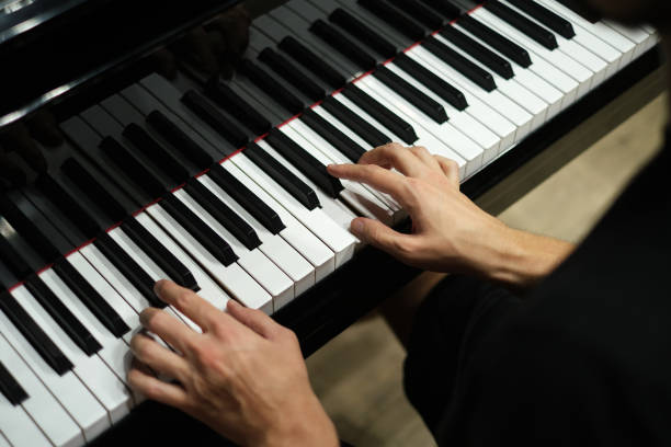 istock hands of a man playing the piano close-up 1440823726