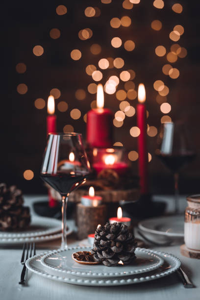 istock Rustic table decor for Christmas or New Year family dinner. Centrepiece with red candle, dry orange, cone, cinnamon, anise. Zero waste eco-friendly home. Cozy atmosphere, dark background. Close up 1440825419