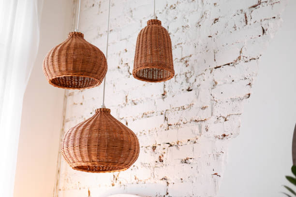istock three rattan chandeliers different forms on white brick wall background. Straw lampshade in cozy living room. Eco-friendly interior design using natural materials. Scandinavian interior. copy space 1440830029