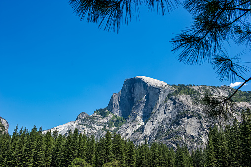 Two views of Half Dome at Yosemite National Park in California.  One side is a sheer face while the other three sides are smooth and round.  Its' elevation is 8,839' and is a very popular tourist attraction in the park.