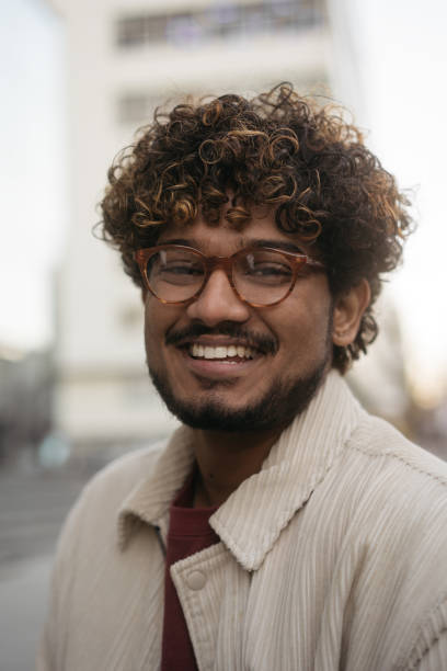 istock Smart smiling Indian student wearing eyeglasses looking at camera in university campus. Education concept 1440835149