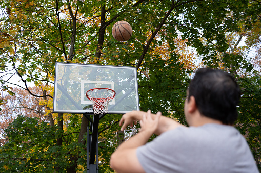 Latin man playing with a basketball