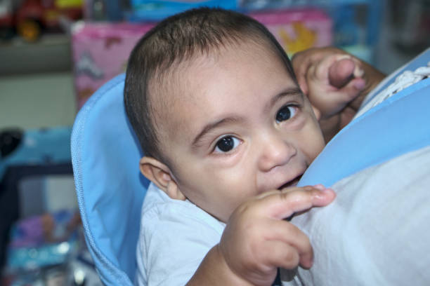 istock latin baby in blue charger looking at camera 1440835658