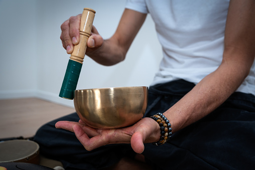 Hands Playing Tibetan Chanting Bowl - Mantra Translation: transforming your impure body, speech and mind into the pure and exalted body, speech and mind of a Buddha