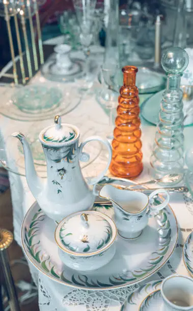 Stylish retro interior. Close-up of vintage fine chinaware on table.
