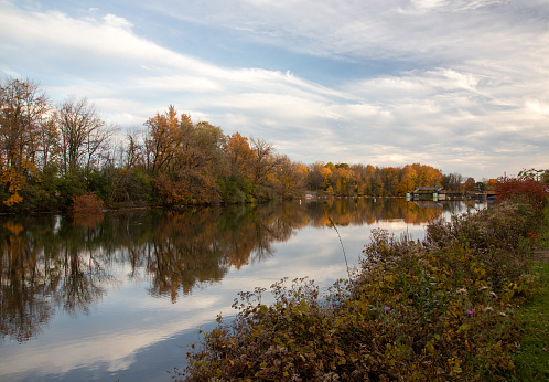 Photograph of Lock 25 on the Erie Canal in New York during autumn with the fall foliage reflected in the water.