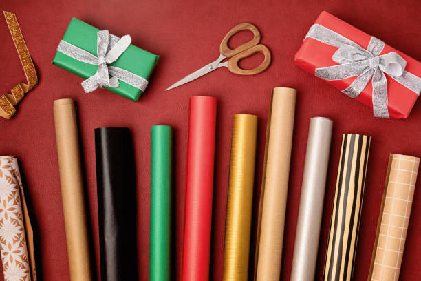 istock Christmas background with gift boxes and rolls of kraft wrapping paper 1440841323