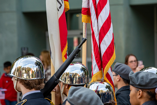 California Capitol Veterans Day Parade 2022.  “Welcome Home” ceremony for the first time in more than 50 years. Parade honored hometown heroes of the 319th Signal Battalion. The Rio Linda JROTC color guard with Refection in helmets along parade.