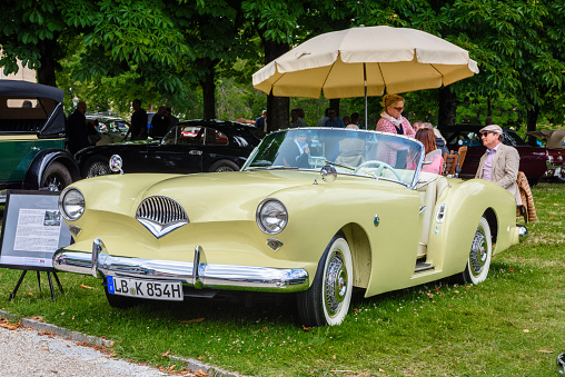 Baden-Baden, Germany - 14 July 2019: white beige Kaiser Darrin cabrio roadster 1954 is parked in town center, oldtimer meeting event in the center of Baden-Baden