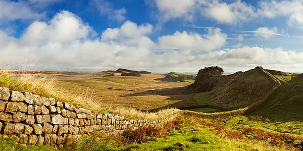 English countryside with Hadrian's Wall in beautiful early morning light. Photographed near the Housesteads Fort. A seamlessly stitched panoramic image with a total size of 60 megapixels.