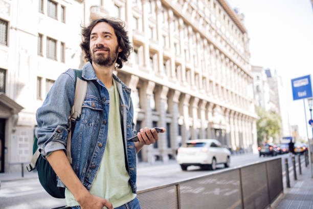 istock Young man on a journey taking a break on the street 1440863365