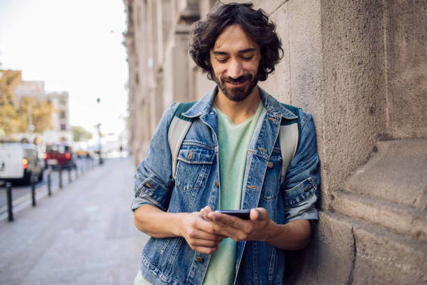 istock Young man on a journey taking a break on the street 1440863374