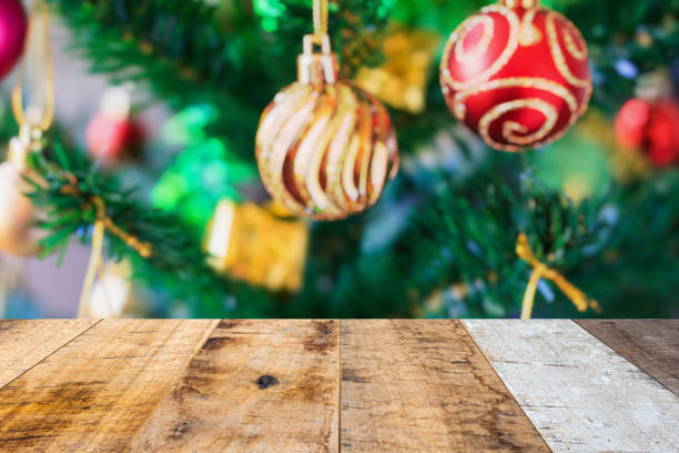istock Empty wood table top with blur Christmas tree with bokeh light background 1440864232
