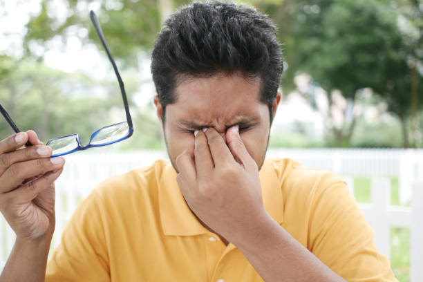 istock upset man suffering from strong eye pain 1440864788