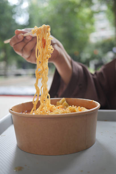 istock slow motion of eating spaghetti with a chopsticks. 1440864791