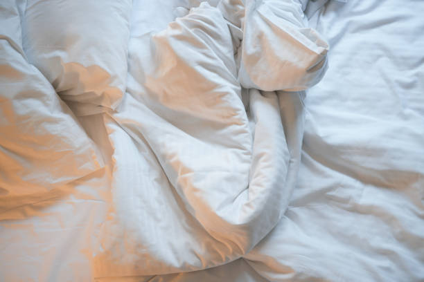 istock messy bed in early morning , messy bed after waking up 1440864793