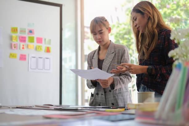 istock Smiling female graphic designer working with new startup project in modern office. 1440867069