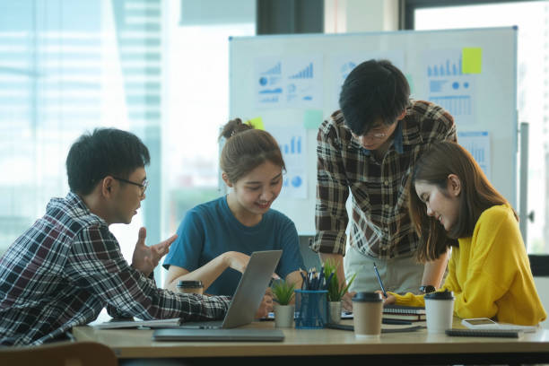 istock Young businesspeople discussing creative project together at bright office. 1440867132