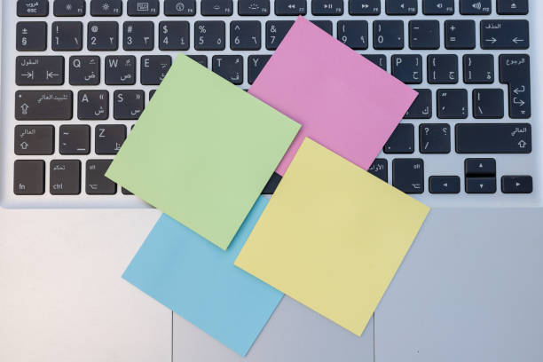 istock Laptop keyboard full of colorful sticky notes.Work overload concept 1440873620